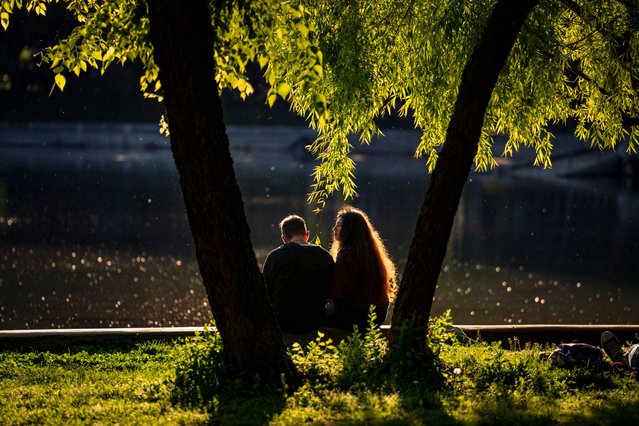 Youngsters enjoy a sunny afternoon by the lake in Cismigiu park, in Bucharest, Romania, Wednesday, April 24, 2024. (Photo by Vadim Ghirda/AP Photo)