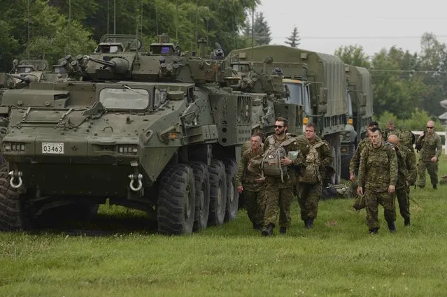 Troops from the 3rd Canadian Division, tasked with reinforcing the battle against wildfires in northern Saskatchewan, arrive in Prince Albert, Saskatchewan July 6, 2015 in a photo released by the Canadian Forces. The Canadian military has been called in to help fight wildfires in the Western province of Saskatchewan, where 112 active fires have forced the evacuation of more than 13,000 people and threatened several remote towns on Monday. (Photo by MCpl Melanie Ferguson/Reuters/Canadian Forces)