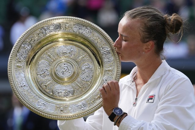 Barbora Krejcikova of the Czech Republic kisses her trophy after defeating Jasmine Paolini of Italy in the women's singles final at the Wimbledon tennis championships in London, Saturday, July 13, 2024. (Photo by Kirsty Wigglesworth/AP Photo)