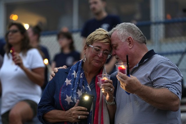 People embrace during a vigil for Corey Comperatore, the former fire chief shot and killed at a weekend rally for former President Donald Trump,  Wednesday, July 17, 2024, at Lernerville Speedway in Sarver, Pa. (Phoot by Matt Slocum/AP Photo)