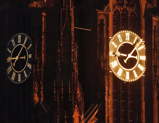 Sun light shines on one of the clocks on the cathedral in Frankfurt, Germany, on a cold and sunny Friday, January 6, 2017. (Photo by Michael Probst/AP Photo)