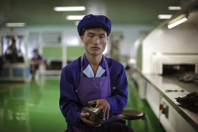 In this June 22, 2016, photo, Kang Jong Jin, a 28-year old former soldier who attaches soles onto shoes at a shoe factory in Wonsan, North Korea, poses for a portrait at his work station. Kang, who has been working longer hours during this 200-day “speed campaign” in line with North Korean leader Kim Jong Un's vows to raise the nation's standard of living and energize his five-year plan to develop economy, says that he wants to contribute to Kim's plan by taking courses to improve his scientific and technological skills. (Photo by Wong Maye-E/AP Photo)