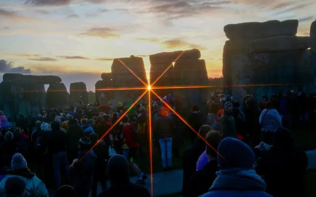 People gather at Stonehenge in Wiltshire on December 22, 2019, to mark the winter solstice, and to witness the sunrise after the longest night of the year. (Photo by Rob Welham)