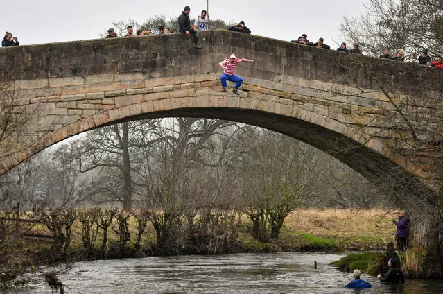 A charity competitor jumps off of Okeover Bridge into the River Dove during the Mapleton raft race and bridge jump, at Mapleton, near Ashbourne, Derbyshire, as part of New Year's Day celebrations on January 1, 2020. (Photo by Jacob King/PA Images via Getty Images)