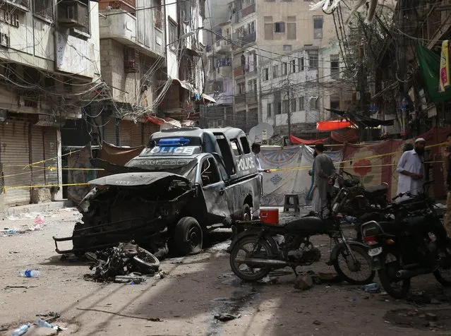 Aftermath of an explosion in Karachi, Pakistan, 17 May 2022. One person was killed on 16 May and at least a dozen were injured, including police officers, when an improvised explosive device (IED) went off near a police van. (Photo by Rehan Khan/EPA/EFE)
