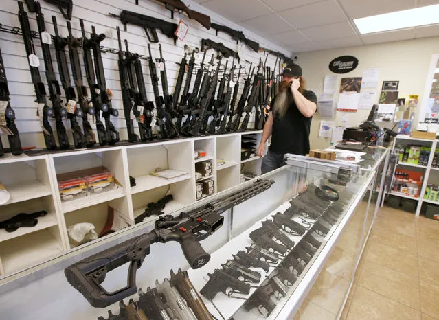 An AR-15 sits on a display case as Willy Ludlow, owner of  the “Ready Gunner” gun store in Provo, Utah, U.S., June 21, 2016. (Photo by George Frey/Reuters)