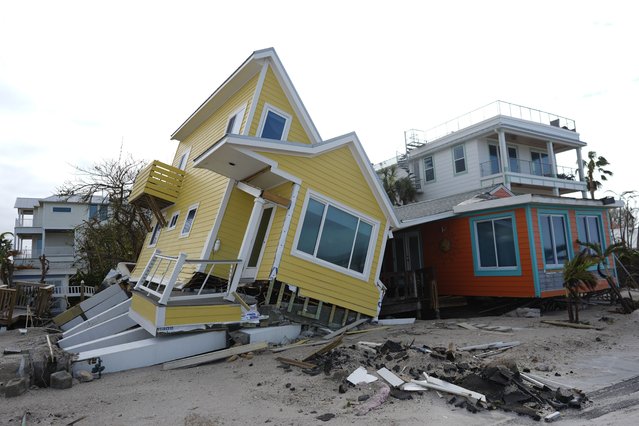 A house lies toppled off its stilts after the passage of Hurricane Milton, in Bradenton Beach on Anna Maria Island, Fla., Thursday, October 10, 2024. (Photo by Rebecca Blackwell/AP Photo)