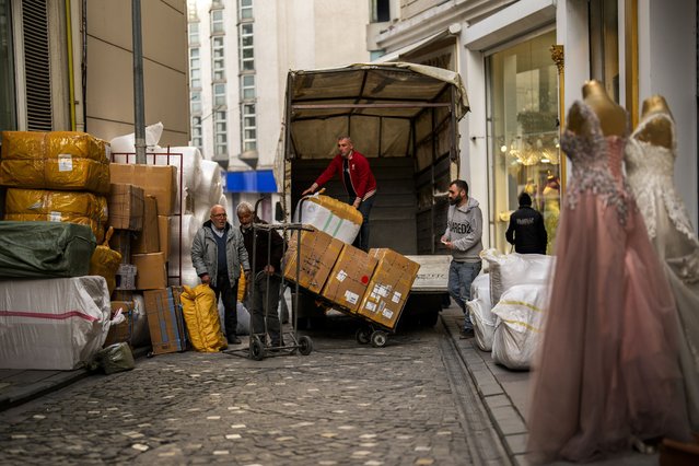 Workers upload goods inside a track at Eminonu commercial quarter in Istanbul, Turkey, Monday, February 5, 2024. Turkey has seen its fifth central bank leader depart in as many years as Hafize Gaye Erkan, the first woman in the top role, stepped down after just eight months in the job. (Photo by Francisco Seco/AP Photo)