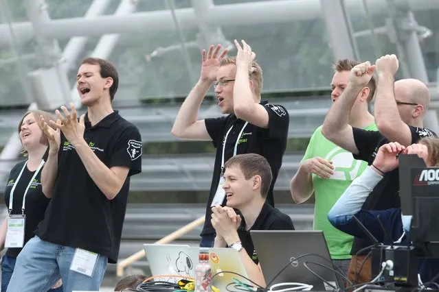 The team of the Technical University of Dortmund celebrates during a group match of the 20th RoboCup in Leipzig, Germany, June 30, 2016. (Photo by Sebastian Willnow/EPA)