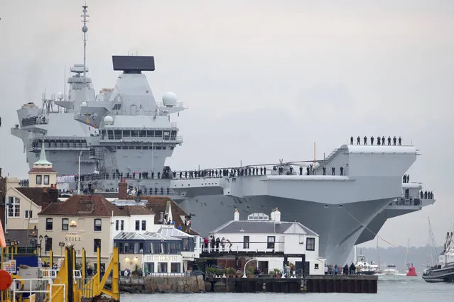 Britain's new flagship HMS Queen Elizabeth arrives in Portsmouth, Britain, Wednesday August 16, 2017.  HMS Queen Elizabeth has arrived at its home port in southern England to great fanfare.  Crowds lined the harbor on Wednesday to welcome the ship to Portsmouth Naval Base, where the 919-foot (280-meter) vessel will be based for its estimated 50-year lifespan. (Photo by Steve Parsons/PA Wire via AP Photo)