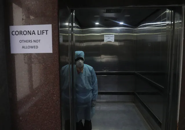 An Indian lift operator stands inside a dedicated lift for people suspected to be infected with the new corona virus at the Government Gandhi Hospital in Hyderabad, India, Monday, March 2, 2020. Coronavirus has spread to more than 60 countries, and more than 3,000 people have died from the COVID-19 illness it causes. (Photo by Mahesh Kumar A./AP Photo)