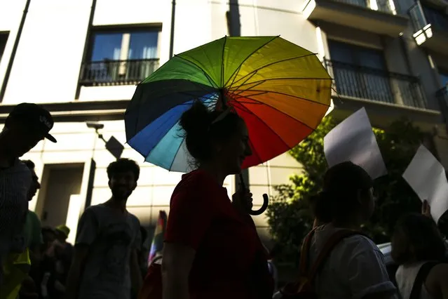 People march during the LGBTQ Pride March in Istanbul, Turkey, Sunday, June 26, 2022. Dozens of people were detained in central Istanbul Sunday after city authorities banned a LGBTQ Pride March, organisers said. (Photo by Emrah Gurel/AP Photo)