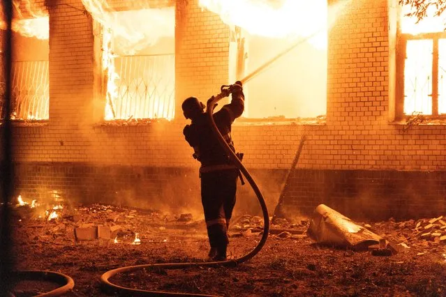 A firefighter extinguishes a burning hospital building hit by a Russian missile strike, as Russia's attack on Ukraine continues, in Mykolaiv, Ukraine on August 1, 2022. (Photo by Stanislav Kozliuk/Reuters)