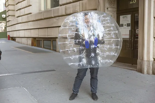 A van in a bubble walking down Broadway near the Charging Bull and Bowling Green in New York on March 24, 2020, amid the COVID-19 Coronavirus pandemic. (Photo by Taidgh Barron/The New York Post)