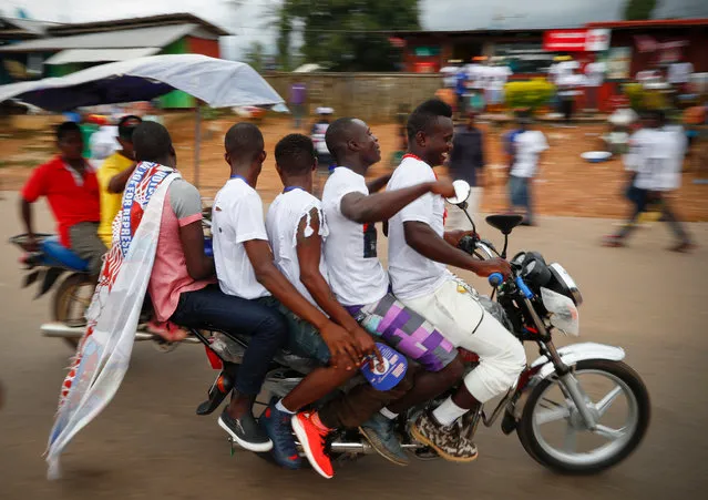 Supporters of Liberian presidential candidate George Weah ride five up, on a motorcycle during a campaign rally in Buchanan, Liberia, 30 September 2017 (issued 01 October 2017). Liberians will head to the polls on 10 October in the very first African nation to obtain independence in 1847. These elecions are hoped to be the first peaceful and democratic transfer of power from Africa's first woman democratically elected president, Ellen Johnson-Sirleaf to a new leader who has to continue in the efforts to rebuilding the country, following nearly two decades of brutal civil war. (Photo by Nic Bothma/EPA/EFE)