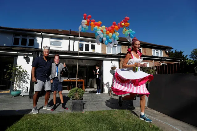 Anna Bassil runs a marathon distance dressed as a cake around her garden in St Albans. The London Marathon was due to take place today but was postponed following the outbreak of the coronavirus disease (COVID-19), St Albans, Britain, April 26, 2020. (Photo by Paul Childs/Reuters)