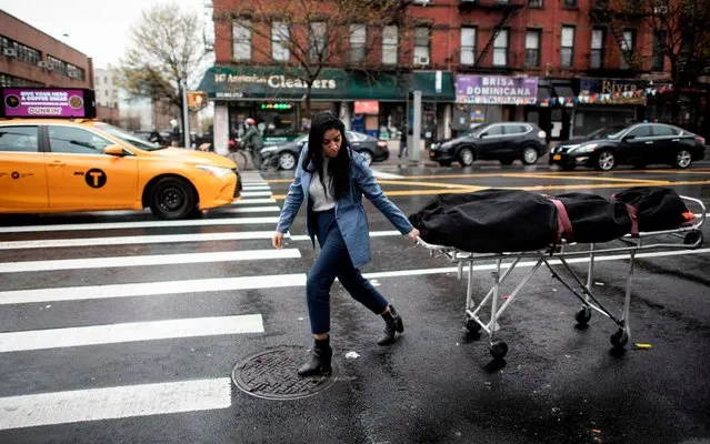 Alisha Narvaez Manager at International Funeral & Cremation Services transports a body to the funeral home on April 24, 2020 in the Harlem neighborhood of New York City. For many families already in distress, finding a funeral home in New York that will accept the body of a loved one is a headache; in Harlem, International Funeral home tries not to turn anyone away, even if it means being under stress. (Photo by Johannes Eisele/AFP Photo)