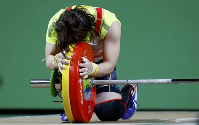 2016 Rio Olympics, Weightlifting, Final, Women's 48kg, Riocentro, Pavilion 2, Rio de Janeiro, Brazil on August 6, 2016. Hiromi Miyake (JPN) of Japan embraces the weights after winning the bronze medal. (Photo by Kai Pfaffenbach/Reuters)