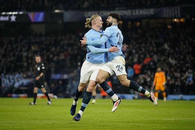 Manchester City's Erling Haaland, left, celebrates with Manchester City's Josko Gvardiol after scoring his sides first goal during the Champions League playoff first leg soccer match between Manchester City and Real Madrid at the Etihad Stadium in Manchester, England, Tuesday, February 11, 2025. (Photo by Dave Thompson/AP Photo)