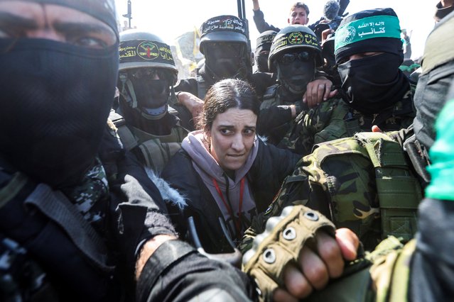 Palestinian militants surround hostage Arbel Yehoud, held in Gaza since the deadly October 7 2023 attack, on the day they hand her to members of the International Committee of the Red Cross (ICRC) as part of a ceasefire and a hostages-prisoners swap deal between Hamas and Israel, in Khan Younis in the southern Gaza Strip, on January 30, 2025. (Photo by Ramadan Abed/Reuters)
