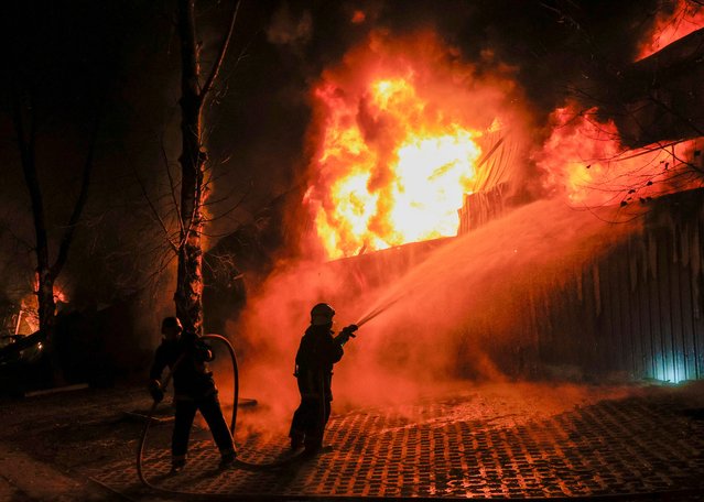 Ukrainian rescuers work to extinguish a fire at the site of a drone strike in Kharkiv, northeastern Ukraine, late 26 March 2025, amid the Russian invasion. A Russian large-scale drone attack on Kharkiv overnight injured at least 13 people, including two children, according to the Prosecutor General of Ukraine. Ukrainian air defenses shot down 42 of the 86 drones launched, with 26 others lost, according to the Air Force Command of Ukraine. (Photo by Sergey Kozlov/EPA/EFE)
