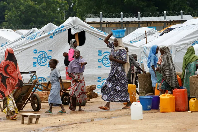 Women gather at a water collecting point at the internally displaced people's camp in Bama, Borno State, Nigeria, August 31, 2016. (Photo by Afolabi Sotunde/Reuters)