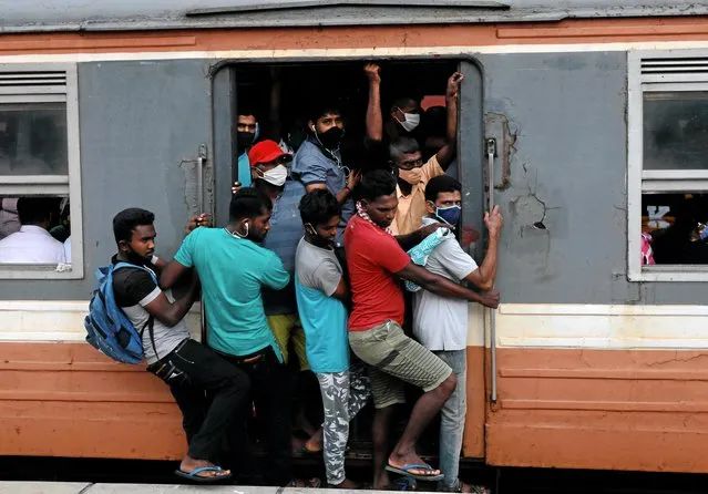 Passengers wearing protective masks travel on an over crowded train towards capital city, amid concerns about the spread of the coronavirus disease (COVID-19), in Colombo, Sri Lanka, July 8, 2020. (Photo by Dinuka Liyanawatte/Reuters)