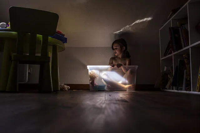 “Tea Time in the Hut”. Little discussion with a doll in a plastic box, not inherently beautiful. But with this slice of light, it looks like a bubble invented to dream in an imaginative world. Photo location: Paris. (Photo and caption by Karine P./National Geographic Photo Contest)