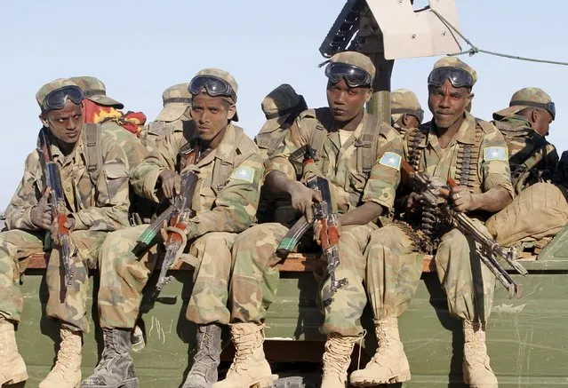 Somalia's army soldiers make their way to the town of Barawe during the second phase of Operation Indian Ocean in this October 4, 2014 file photo. Somalia's inability to pay and even feed its soldiers threatens to undermine years of hard-won military gains against Islamist al Shabaab rebels, with corruption sapping morale and weakening the army in the war against the militants. (Photo by Feisal Omar/Reuters)