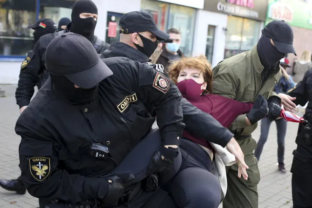 Police officers detain a woman during an opposition rally to protest the official presidential election results in Minsk, Belarus, Saturday, September 19, 2020. (Photo by TUT.by via AP Photo)