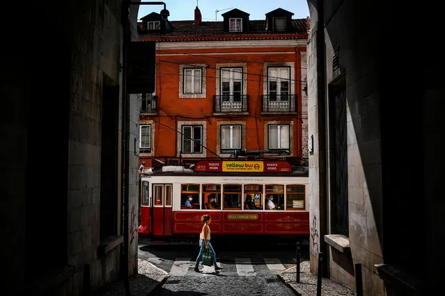 A tram passes by in Bairro Alto neighborhood in Lisbon, Portugal on September 22, 2020. (Photo by Patrícia de Melo Moreira/AFP Photo)