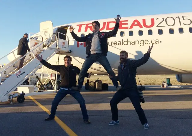 Canadian Liberal leader Justin Trudeau, center, clowns around with campaign team members Tommy Desfosses, left, and Adam Scotti after landing in Montreal, Monday, October 19, 2015. Canadian voters began voting Monday to decide whether to extend Conservative leader Stephen Harper’s near-decade in power or return Canada to its more liberal roots. (Photo by Andy Blatchford/The Canadian Press via AP Photo)