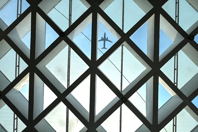 An airplane flies in Chennai on June 12, 2025. (Photo by R.Satish Babu/AFP Photo)