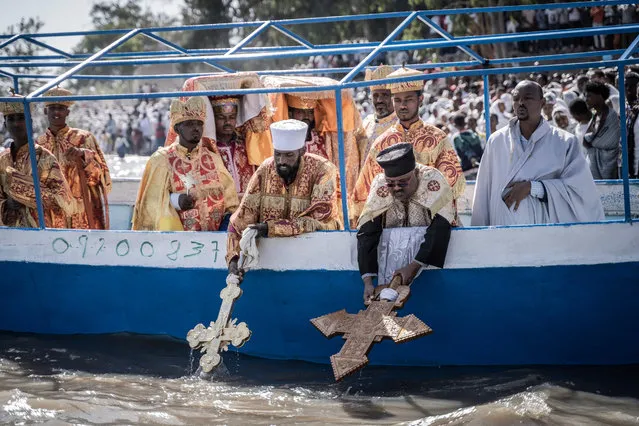 High priests are seen with the ark of the covenant on a boat as they pray during the celebration of the Ethiopian Epiphany on lake Ziway, also known as lake Dembel, Ethiopia, on January 19, 2023. (Photo by Amanuel Sileshi/AFP Photo)
