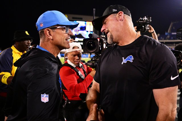 Los Angeles Chargers head coach Jim Harbaugh, left, and Detroit Lions head coach Dan Campbell , right, shake hands after the Pro Football Hall of Fame NFL preseason game Thursday, July 31, 2025, in Canton, Ohio. (Photo by David Dermer/AP Photo)