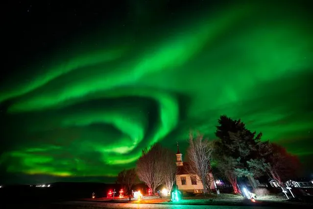 The northern lights over Villingaholtskirkja Church on the south coast of Iceland on Sunday, November 27, 2022. (Photo by Owen Humphreys/PA Images via Getty Images)