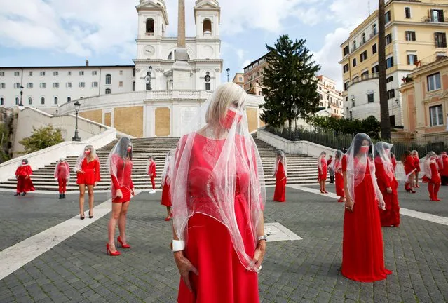 Women dressed in red pose at the Spanish Steps as they record a video to raise awareness of gender-based violence ahead of the International Day for the Elimination of Violence Against Women on November 25, in Rome, Italy, October 26, 2020. (Photo by Remo Casilli/Reuters)