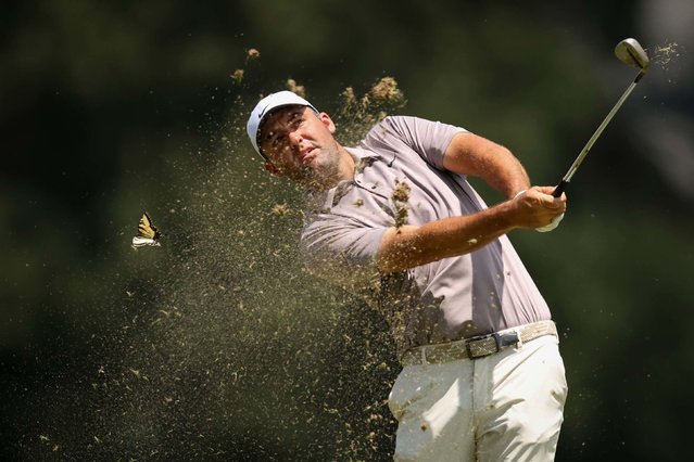 A butterfly flies past Scottie Scheffler as he hits an approach during the final round of the FedEx St. Jud Championship in Memphis, Tennessee, on Sunday, August 10, 2025. (Photo by Stacy Revere/Getty Images)