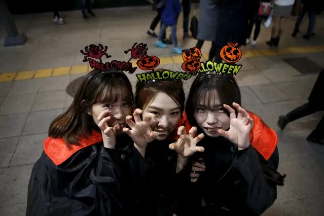 Women in Halloween costume pose for photographs during Halloween celebrations in the downtown of Seoul, South Korea, October 31, 2015. (Photo by Kim Hong-Ji/Reuters)