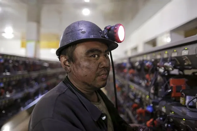 A miner is pictured before he takes his self-rescue equipment off after a day's work at a coal mine of the state-owned Longmay Group on the outskirts of Jixi, in Heilongjiang province, China, October 24, 2015. (Photo by Jason Lee/Reuters)