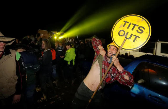 A man holds a “tits out” sign on the final night of the Deni Ute Muster in Deniliquin, New South Wales, Australia, October 1, 2016. (Photo by Jason Reed/Reuters)