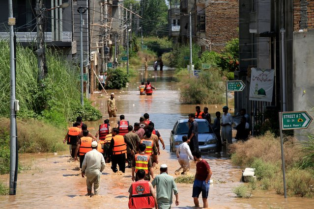 Rescue 1122 workers evacuate people from flooded areas on the outskirts of Peshawar, in Khyber Pakhtunkhwa (KPK) province, Pakistan, 02 September 2025. According to Pakistan's National Disaster Management Authority (NDMA), at least 488 people have died and 359 others have been injured due to monsoon rains in Khyber Pakhtunkhwa province since 26 June. (Photo by Bilawal Arbab/EPA)