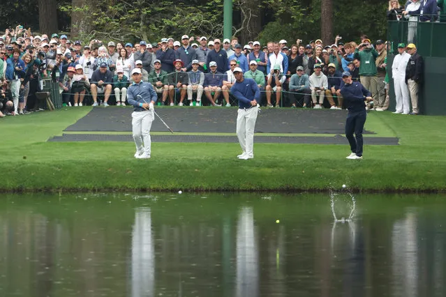 Tom Kim of South Korea, Tiger Woods of the United States and Rory McIlroy of Northern Ireland skip their ball across the pond on the 16th hole during a practice round prior to the 2023 Masters Tournament at Augusta National Golf Club on April 03, 2023 in Augusta, Georgia. (Photo by Christian Petersen/Getty Images)