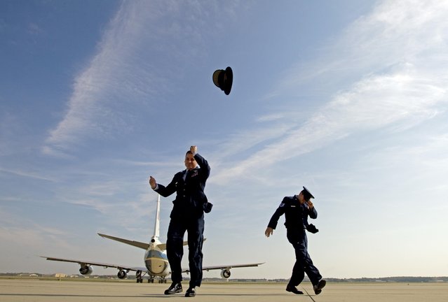 89th Airlift Wing Vice Commander Col. Christopher M. Thompson loses his hat with the blast from Air Force One, with President Barack Obama aboard, as it departs from Andrews Air Force Base, Md., Thursday, October 20, 2016, en route to Miami to encourage people to sign up for health care coverage under the Affordable Care Act during an upcoming enrollment period. (Photo by Jose Luis Magana/AP Photo)