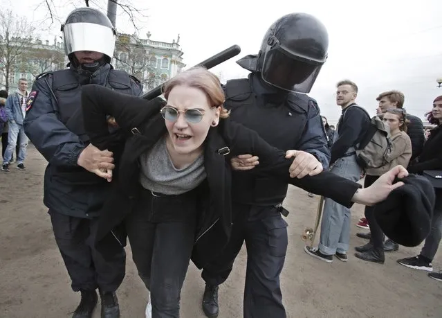 Russian police detain a protester at a demonstration against President Vladimir Putin in St.Petersburg, Russia, Saturday, May 5, 2018. (Photo by Dmitri Lovetsky/AP Photo)