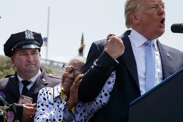 Adrianna Valoy, mother of slain New York Police Detective Milsotis Familia, hugs President Donald Trump as he speaks during the 37th annual National Peace Officers Memorial Service on Capitol Hill, Tuesday, May 15, 2018, in Washington. (Photo by Evan Vucci/AP Photo)