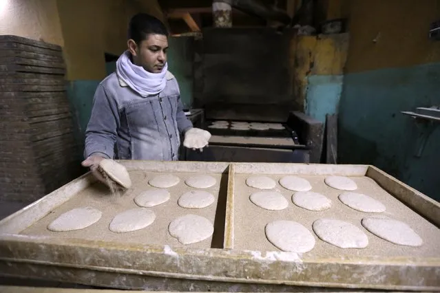 A worker arranges dough to be placed in an oven at a bakery in Cairo, January 8, 2015. (Photo by Mohamed Abd El Ghany/Reuters)