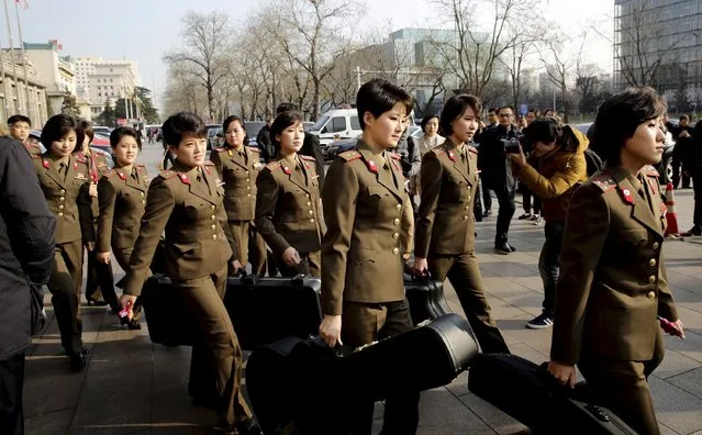 Members of the Moranbong Band from North Korea carry their instruments as they leave a hotel in central Beijing, China, in this December 11, 2015 file picture. The North Korean all-female pop group cancelled their Beijing concert last week when Chinese authorities objected to “anti-American” lyrics in the show, a source with ties to North Korea and China told Reuters on December 18, 2015. (Photo by Reuters/Stringer)
