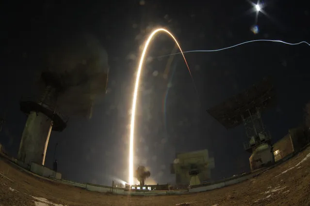 In this photo taken with long time exposure the Soyuz-FG rocket booster with Soyuz MS-03 space ship carrying a new crew to the International Space Station, ISS, blasts off at the Russian leased Baikonur cosmodrome, Kazakhstan, Friday, November 18, 2016. (Photo by Dmitri Lovetsky/AP Photo)