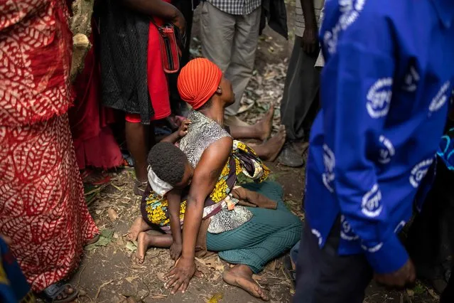 A woman mourns during the funeral of Florence Masika and Zakayo Masereka in Mpondwe on June 18, 2023. (Photo by Stuart Tibaweswa/AFP Photo)